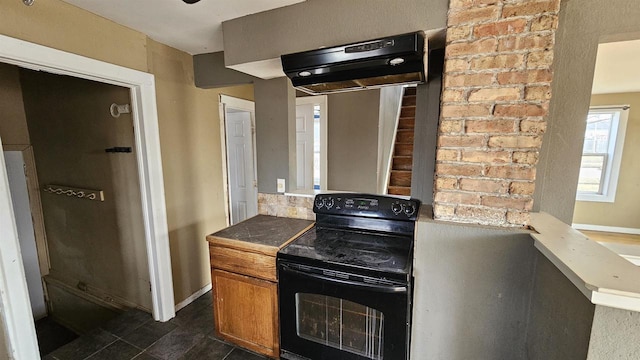 kitchen with black electric range, brown cabinets, baseboards, and ventilation hood