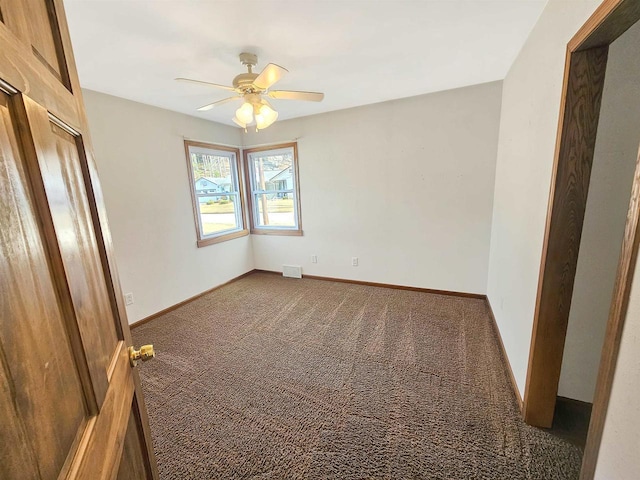 unfurnished room with visible vents, ceiling fan, baseboards, and carpet floors