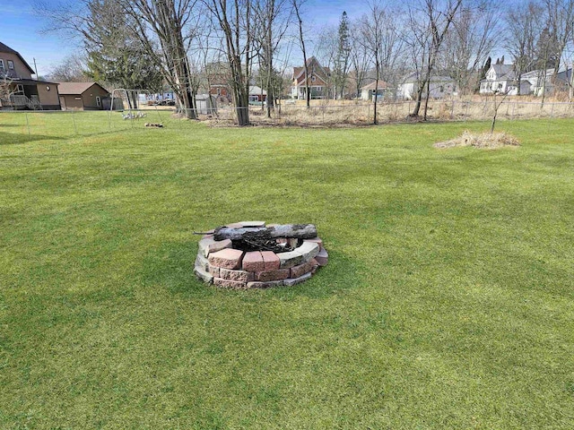 view of yard featuring a fire pit and fence