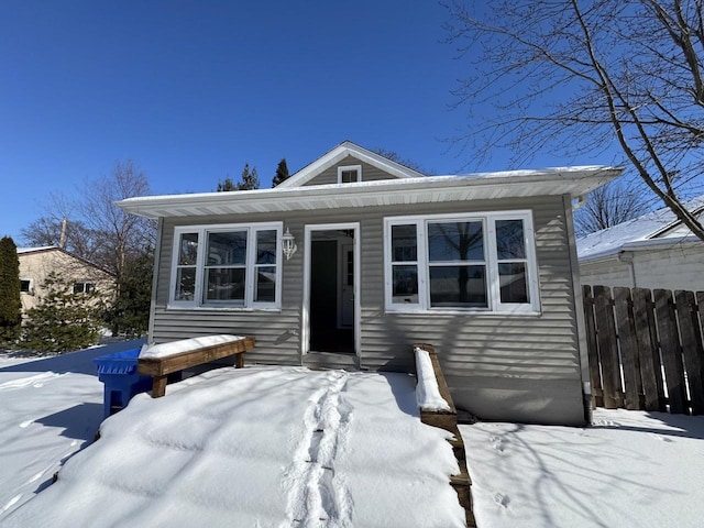 bungalow-style home with fence