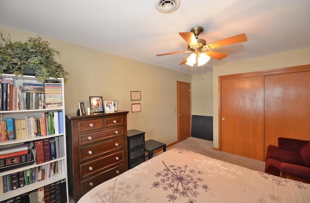 bedroom featuring ceiling fan, visible vents, a closet, and carpet flooring