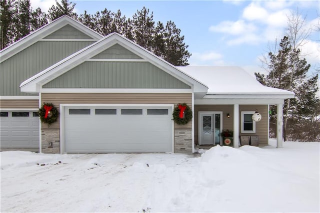 view of front facade with an attached garage and stone siding