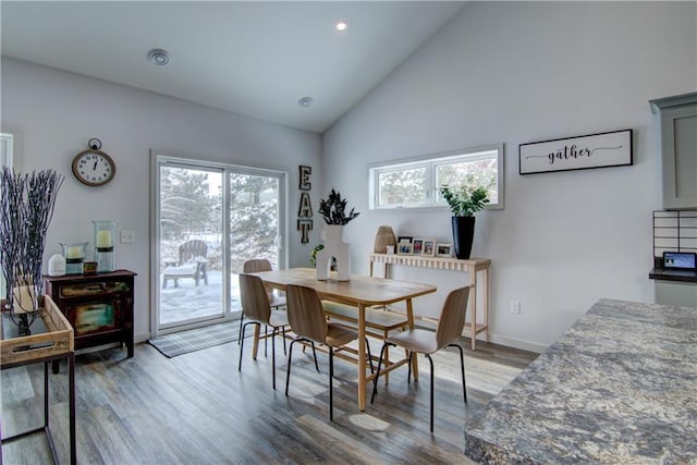 dining room with light wood-style floors, baseboards, high vaulted ceiling, and recessed lighting