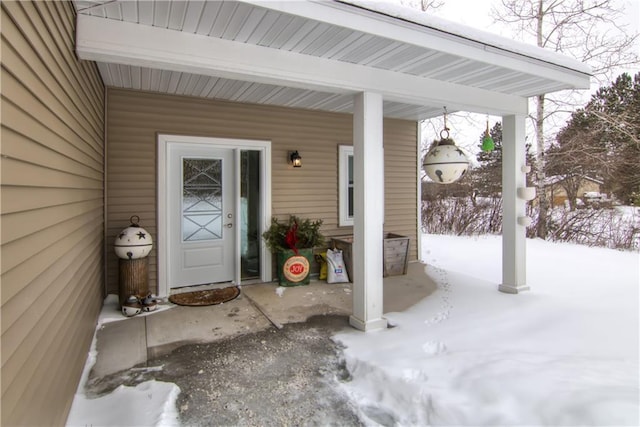 view of snow covered property entrance