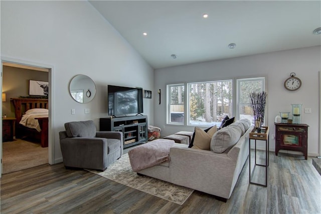 living room with high vaulted ceiling, dark wood finished floors, and recessed lighting