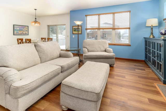 living room with baseboards and wood finished floors