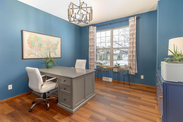 office with an inviting chandelier, wood finished floors, and baseboards