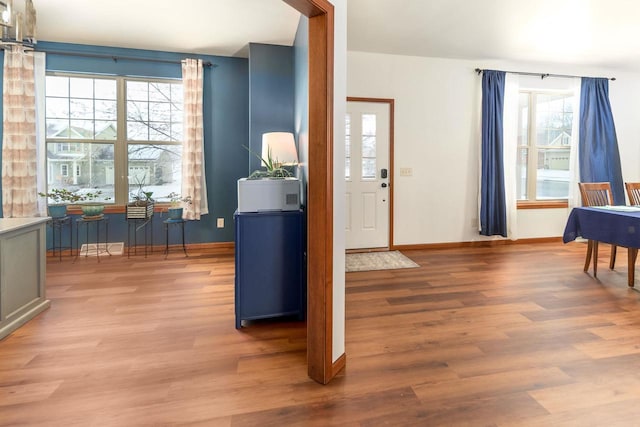 foyer with wood finished floors and baseboards