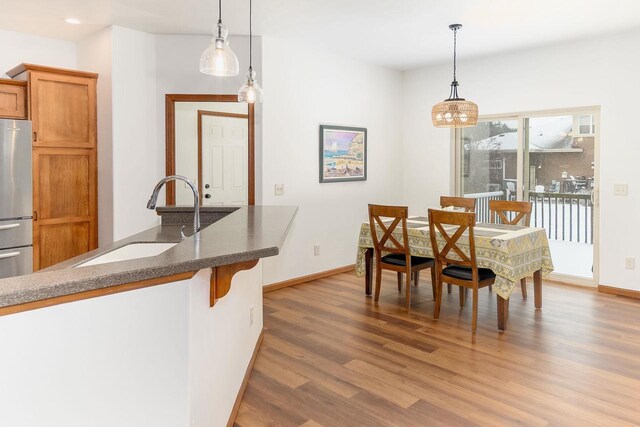 dining room featuring baseboards and wood finished floors