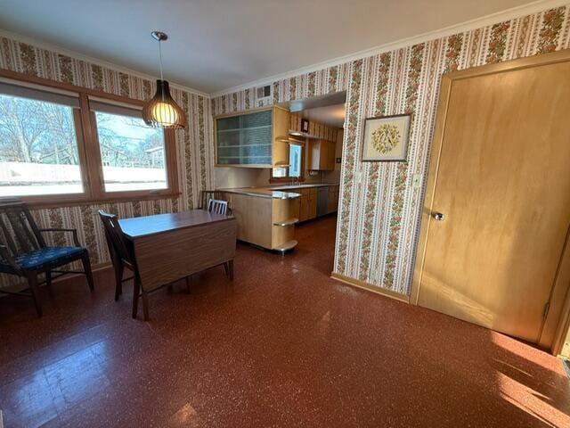 dining room featuring crown molding, dark floors, baseboards, and wallpapered walls