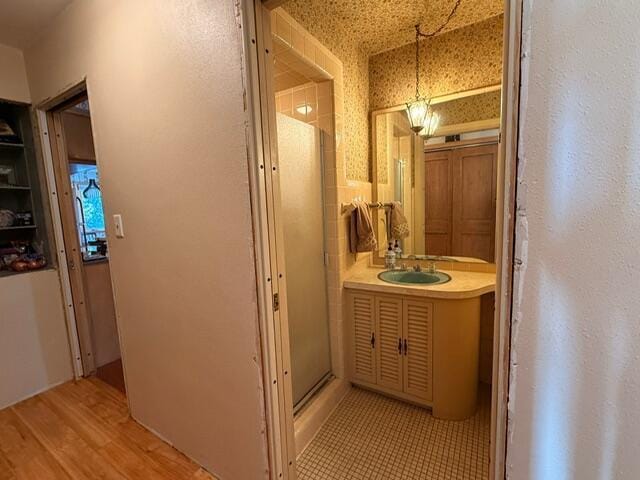 hall with light wood finished floors and a sink