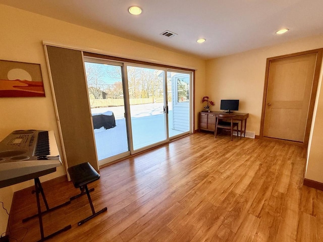 office with light wood-style flooring, visible vents, baseboards, and recessed lighting