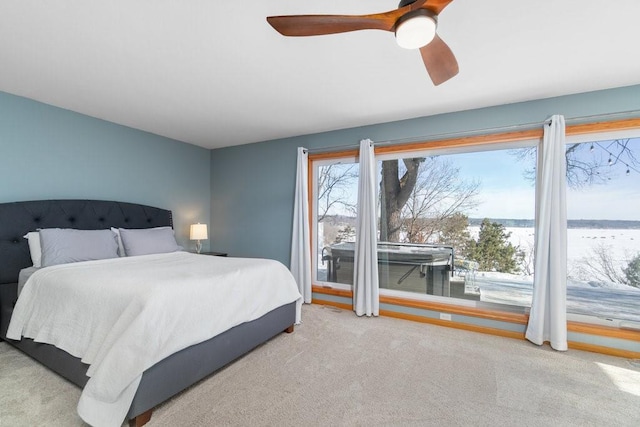 bedroom featuring light carpet and a ceiling fan