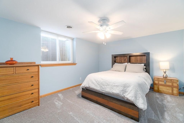 bedroom with light carpet, a ceiling fan, visible vents, and baseboards