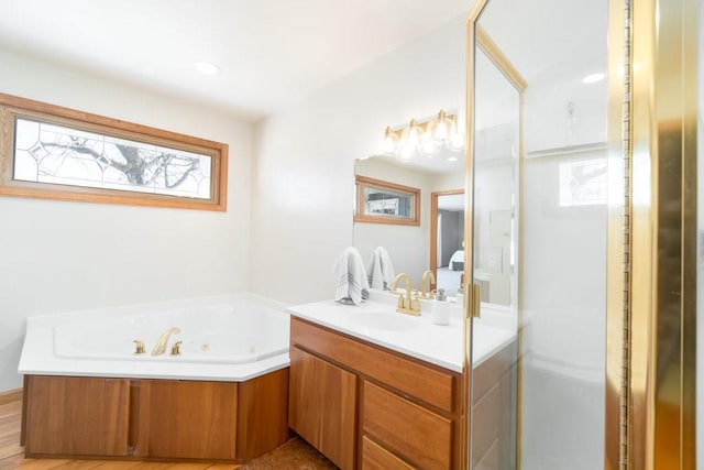 full bath with a shower stall, vanity, and a tub with jets