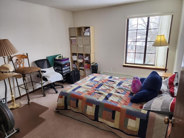 bedroom with carpet and a baseboard radiator