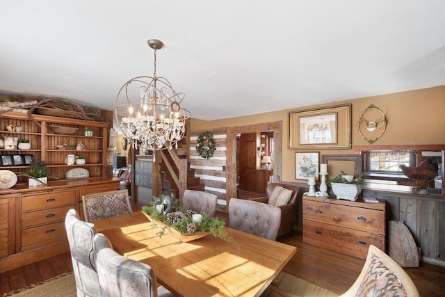 dining space featuring a notable chandelier and wood finished floors