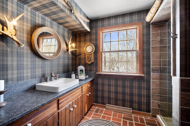 bathroom featuring brick floor, visible vents, vanity, and wallpapered walls