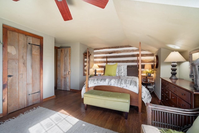 unfurnished bedroom featuring lofted ceiling, ceiling fan, baseboards, and dark wood-style flooring