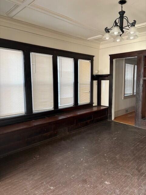 interior space featuring crown molding and a notable chandelier