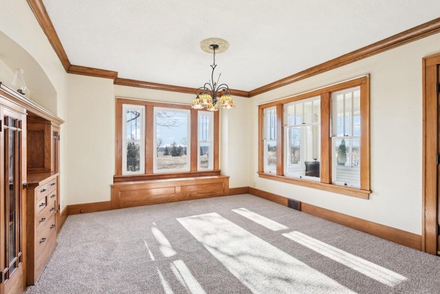 unfurnished dining area featuring baseboards, visible vents, ornamental molding, and carpet flooring