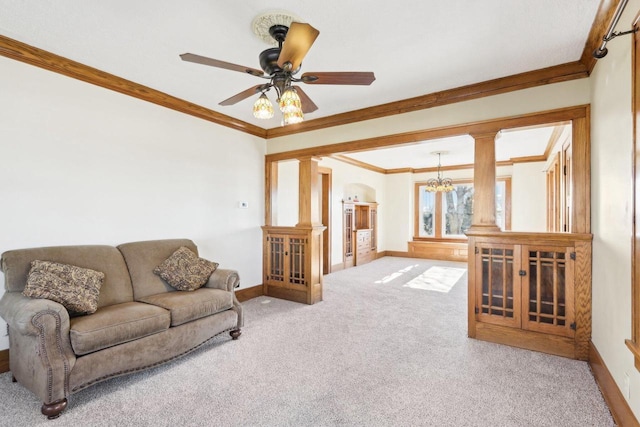 carpeted living area with ornamental molding, decorative columns, and baseboards