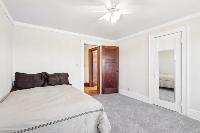 bedroom featuring ornamental molding, light carpet, baseboards, and a ceiling fan