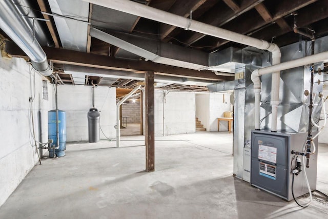 unfinished basement with heating unit and stairway