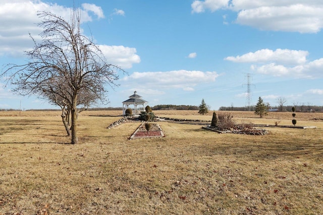 view of yard featuring a rural view and a gazebo