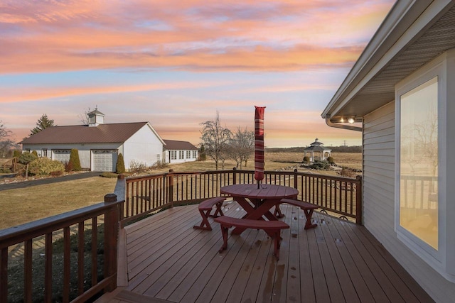 wooden deck with an outbuilding and a lawn