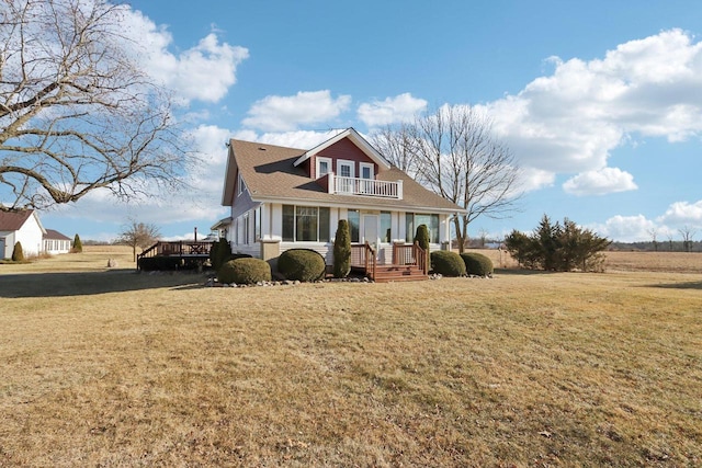 view of front of property with a balcony, covered porch, and a front lawn