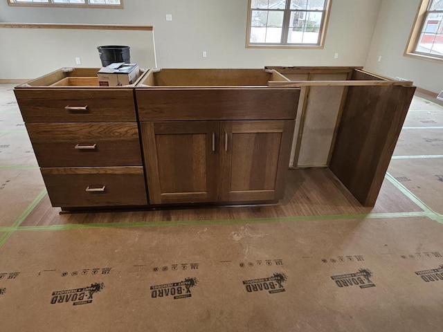 kitchen featuring dark brown cabinetry and wood finished floors