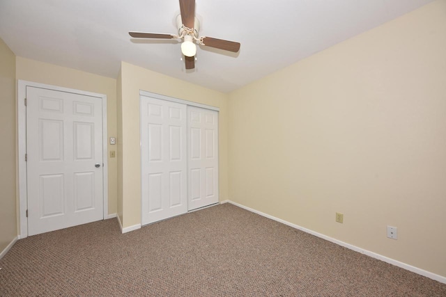 unfurnished bedroom featuring a ceiling fan, carpet, a closet, and baseboards