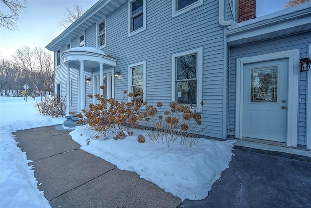 view of snow covered property entrance