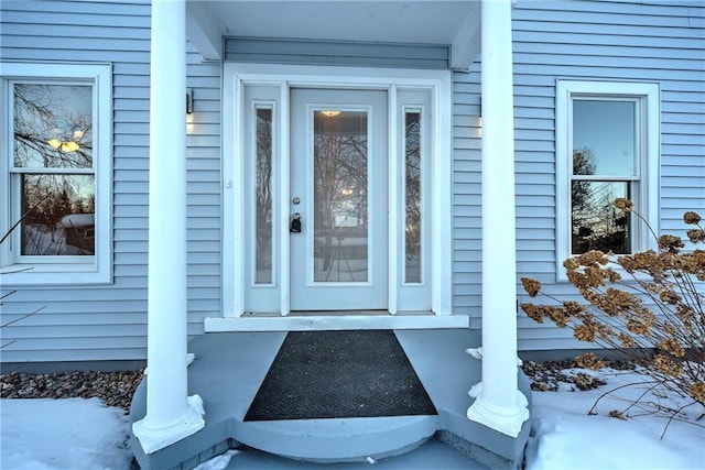 view of snow covered property entrance