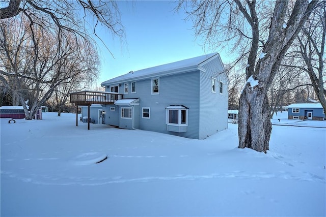 snow covered property featuring a wooden deck