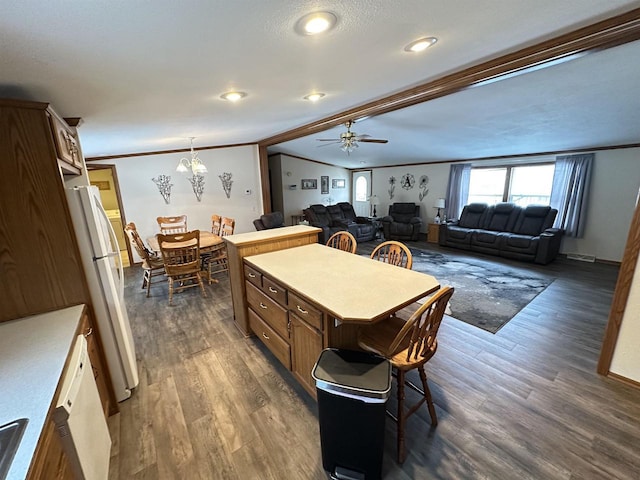 kitchen with open floor plan, light countertops, freestanding refrigerator, and a center island