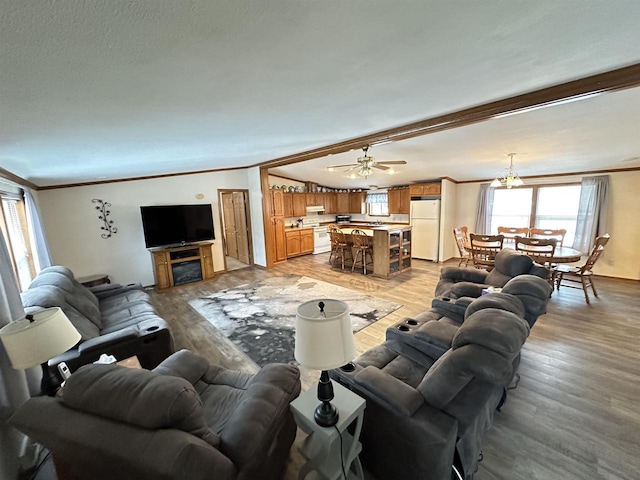 living area with ornamental molding, a fireplace, and light wood finished floors