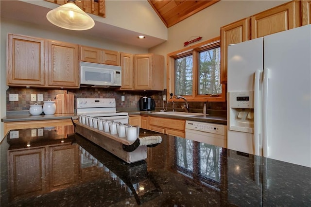 kitchen featuring white appliances, light brown cabinets, pendant lighting, and decorative backsplash