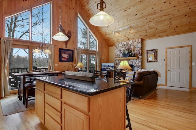 kitchen featuring decorative light fixtures, light wood finished floors, wood ceiling, open floor plan, and a kitchen island