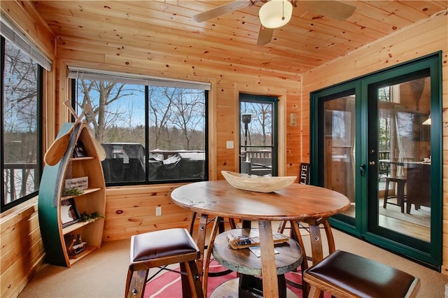 sunroom featuring wood ceiling, a healthy amount of sunlight, and french doors