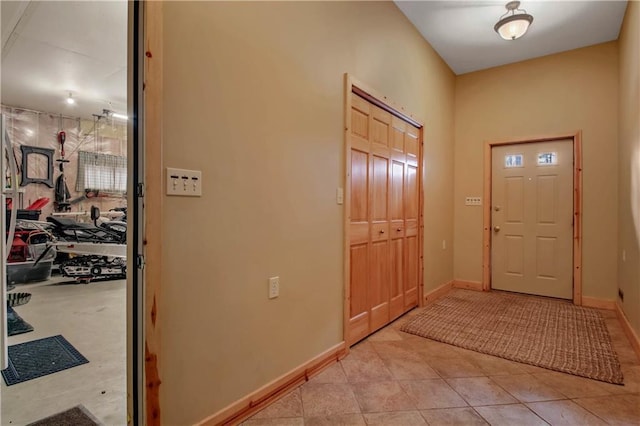 entrance foyer with baseboards and light tile patterned flooring