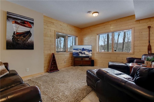 living room featuring light carpet and wood walls