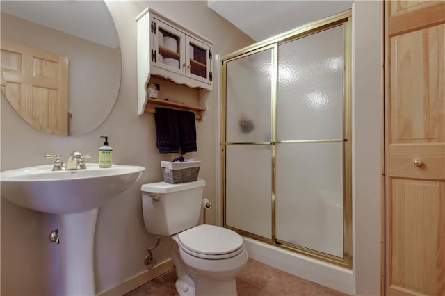 full bathroom with a stall shower, tile patterned flooring, and toilet