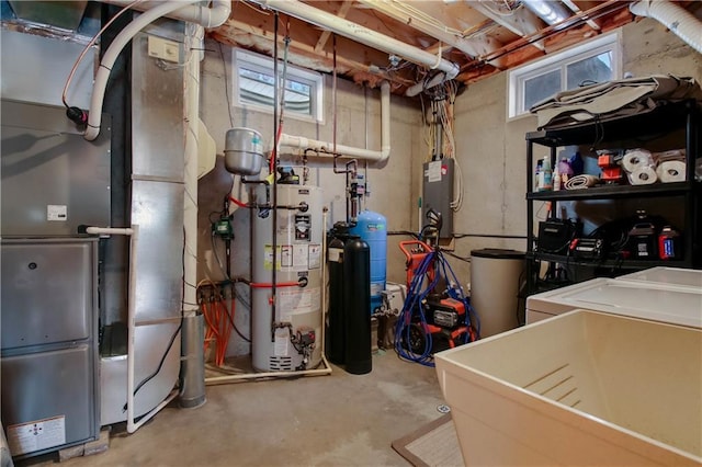 utilities with heating unit, washer and dryer, and gas water heater