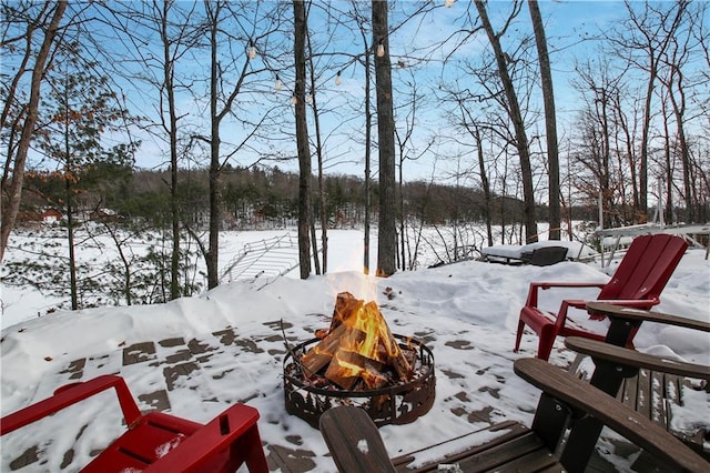 snowy yard featuring a fire pit