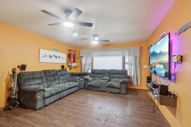 living area featuring visible vents, baseboards, and wood finished floors