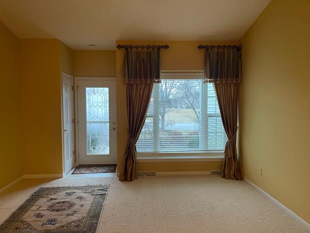 interior space featuring carpet, visible vents, and baseboards