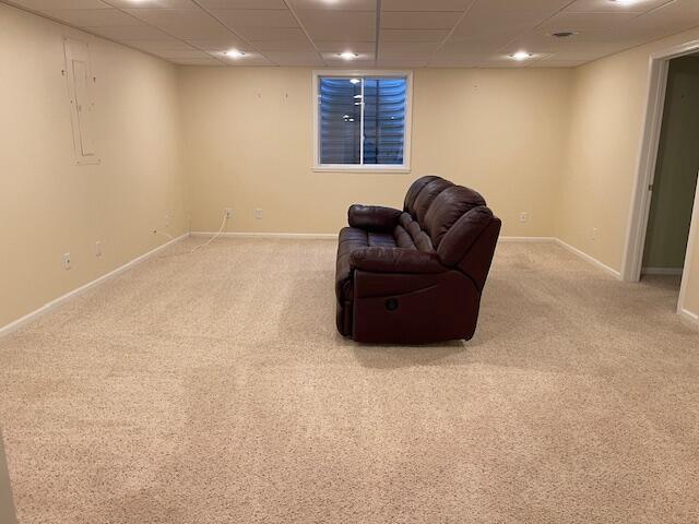 sitting room featuring carpet floors, a paneled ceiling, baseboards, and recessed lighting