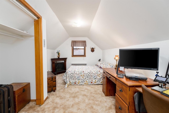 bedroom featuring lofted ceiling, radiator heating unit, and light colored carpet